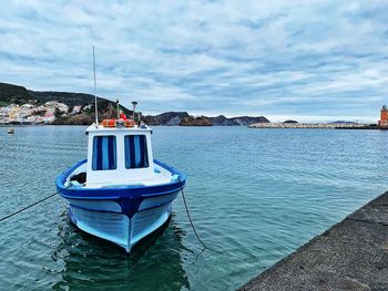 Ship moored on sea against sky