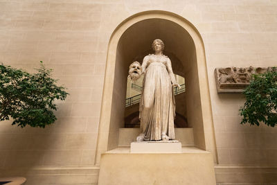 Statue of buddha against building