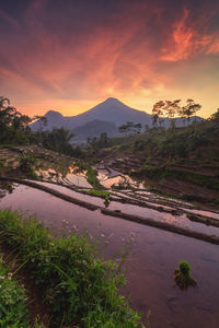 Scenic view of mountains against sky at sunset