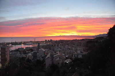 High angle view of townscape against orange sky