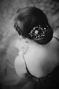 High angle portrait of woman sitting against wall