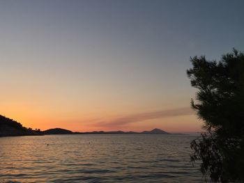 Scenic view of sea against clear sky during sunset