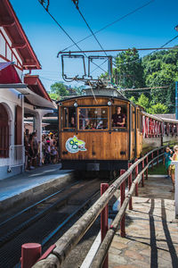 Train at railroad station against sky