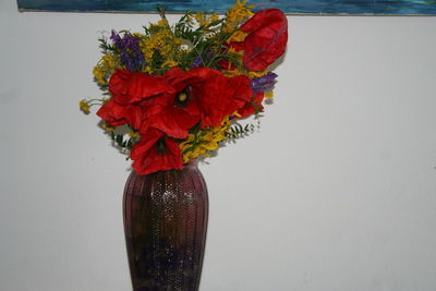 Close-up of red flower vase against wall