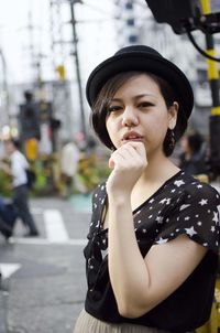 Portrait of smiling young woman standing outdoors