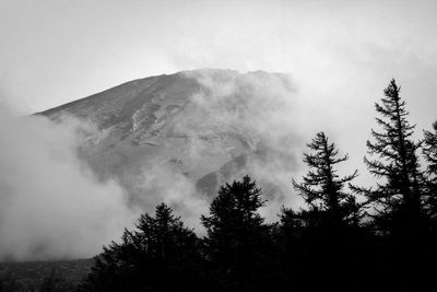 Scenic view of mountains against cloudy sky