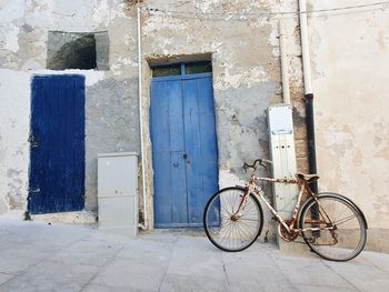 Bicycle against closed door of old building