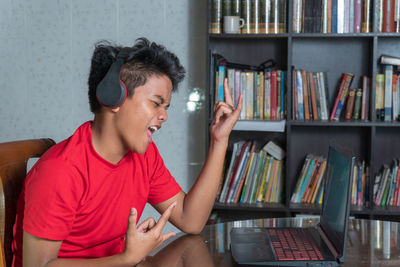 Young woman using mobile phone at home
