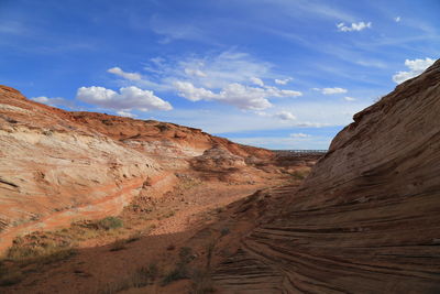 Scenic view of sand dunes against sky