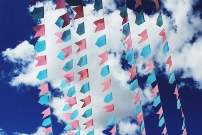 Low angle view of flags against sky