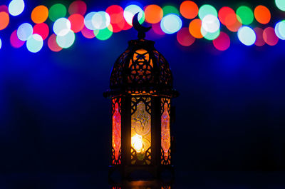 Lantern with colorful bokeh lights for islamic new year and ramadan kareem concept.