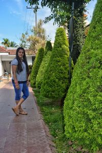 Full length portrait of woman on footpath