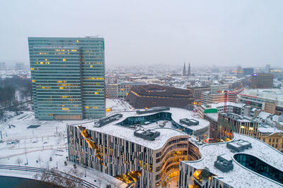 High angle view of city buildings during winter