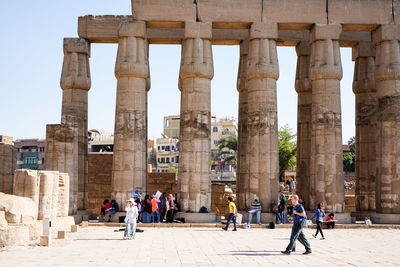 Luxor pillars. carved stone. tourists.