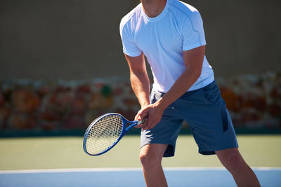 Low section of man playing tennis