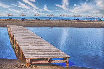 Pier over lagoon against sky in front of the adriatic sea