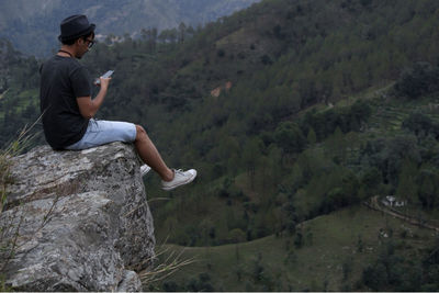 Side view of young man looking at mountain