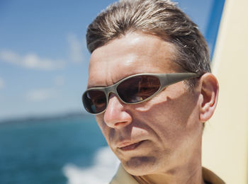 Man wearing sunglasses against sea