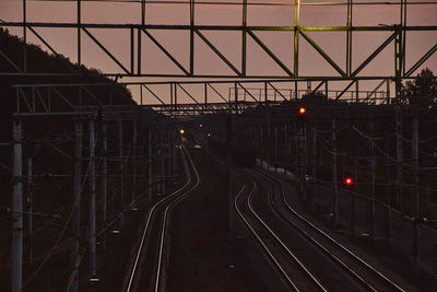 Train on railroad tracks against sky at dusk