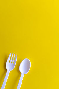 High angle view of yellow object over colored background