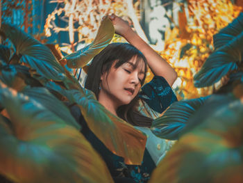 Woman standing amidst leaves