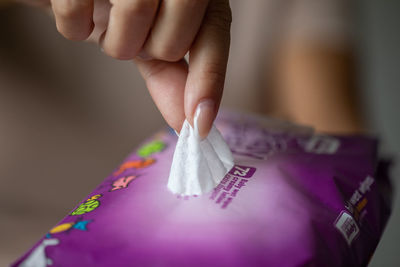 Close-up of hand holding paper