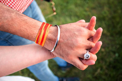 Close-up of man holding hands against blurred background
