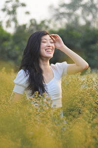 Young woman smiling while standing on land