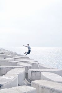 Man jumping into sea