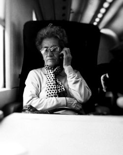 Portrait of senior woman sitting in airplane