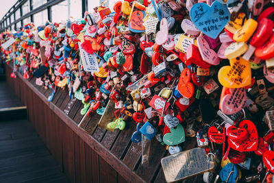 Multi colored padlocks hanging on railing