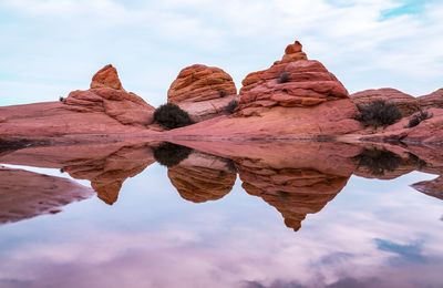 Low angle view of rock formation against cloudy sky