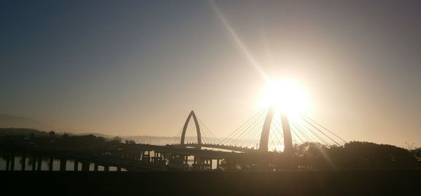 Sun shining through bridge