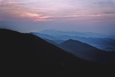 Scenic view of silhouette mountain against sky at sunset