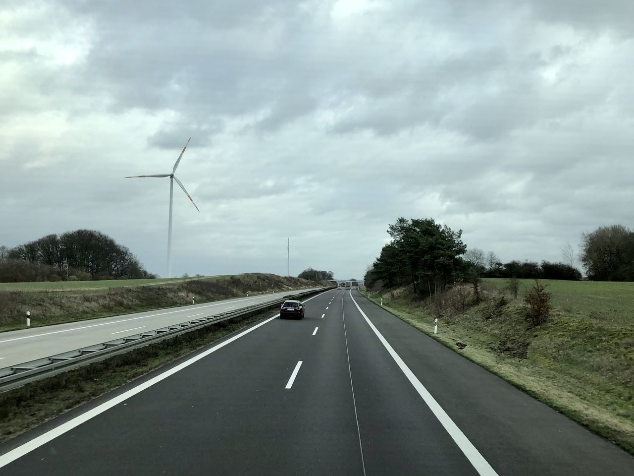 ROAD PASSING THROUGH CAR WINDSHIELD