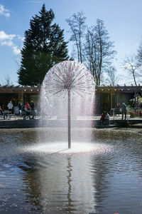 Fountain in park against sky