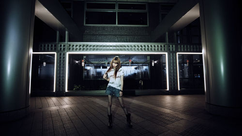 Woman standing in illuminated stage