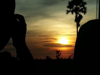 Silhouette of palm trees at sunset