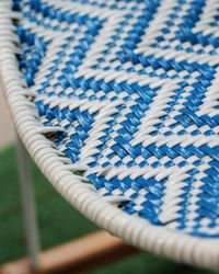 Close-up of white and blue wicker chair