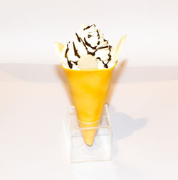 Close-up of drink on table against white background