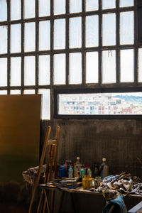 Equipment on table by window in workshop