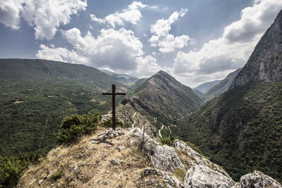 Scenic view of mountains against cloudy sky