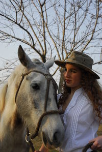 Portrait of young woman with horse