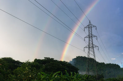 Rain after rain in the sky over high-voltage power poles in rural areas.