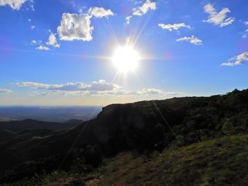 Scenic view of landscape against sky on sunny day