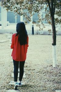 Rear view woman walking in garden