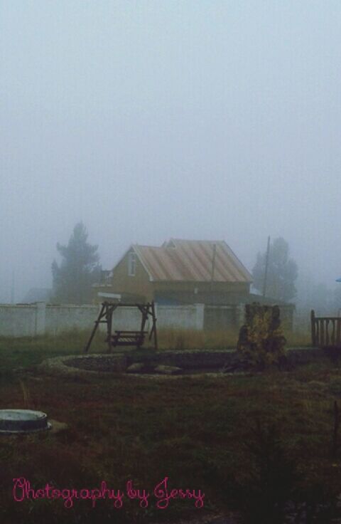 clear sky, copy space, built structure, tree, field, landscape, architecture, transportation, nature, house, building exterior, sky, tranquility, tranquil scene, foggy, grass, day, growth, beauty in nature