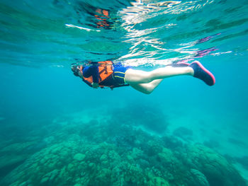 Woman scuba diving in sea