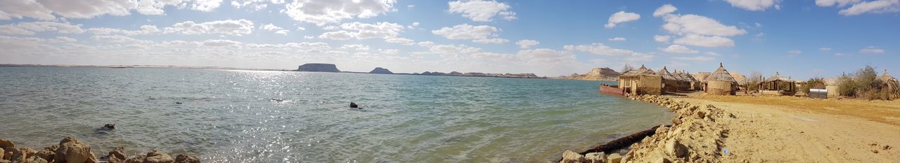 Panoramic view of bay against sky