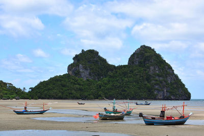 Boats moored on sea against sky